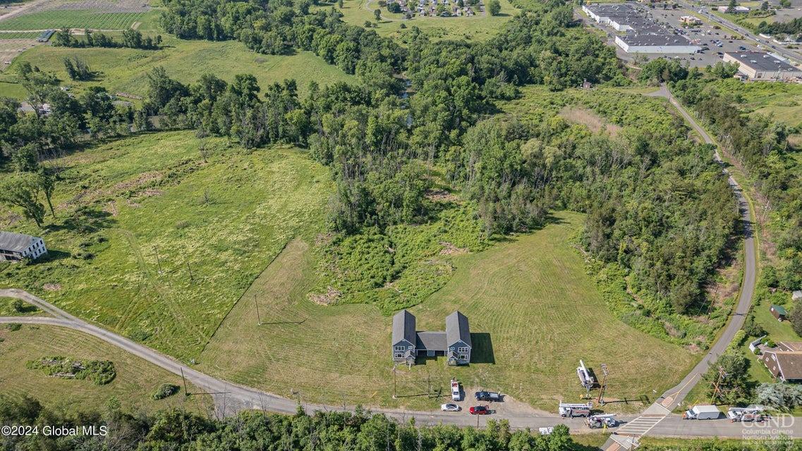 an aerial view of residential houses with outdoor space