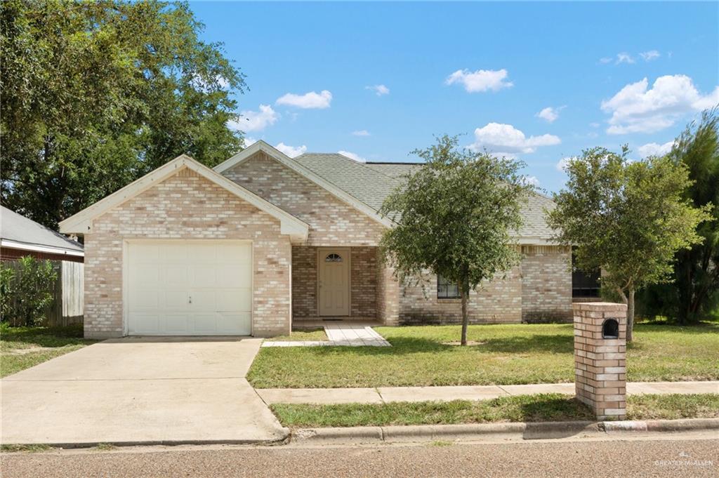 a view of a house with a yard and garage