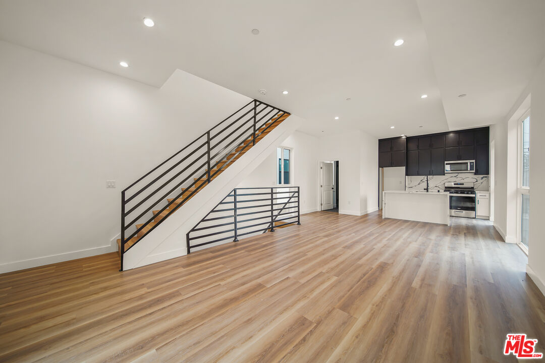 a view of kitchen with furniture and wooden floor