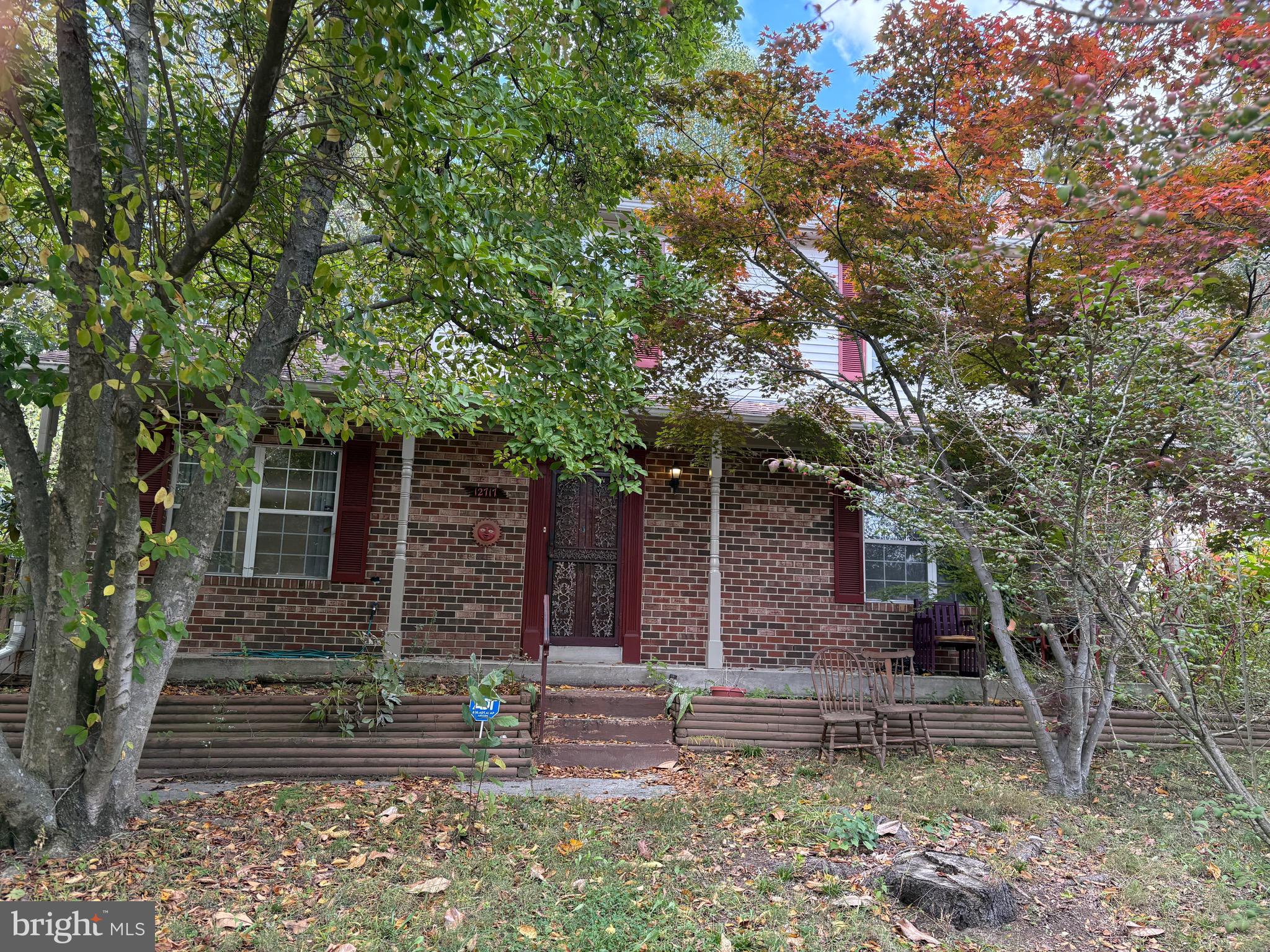 a view of a house with a tree front of it