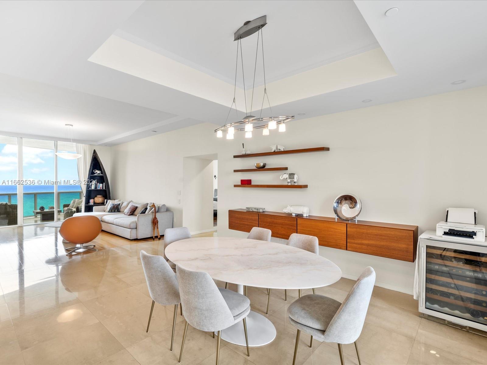 a view of a dining room with furniture and chandelier