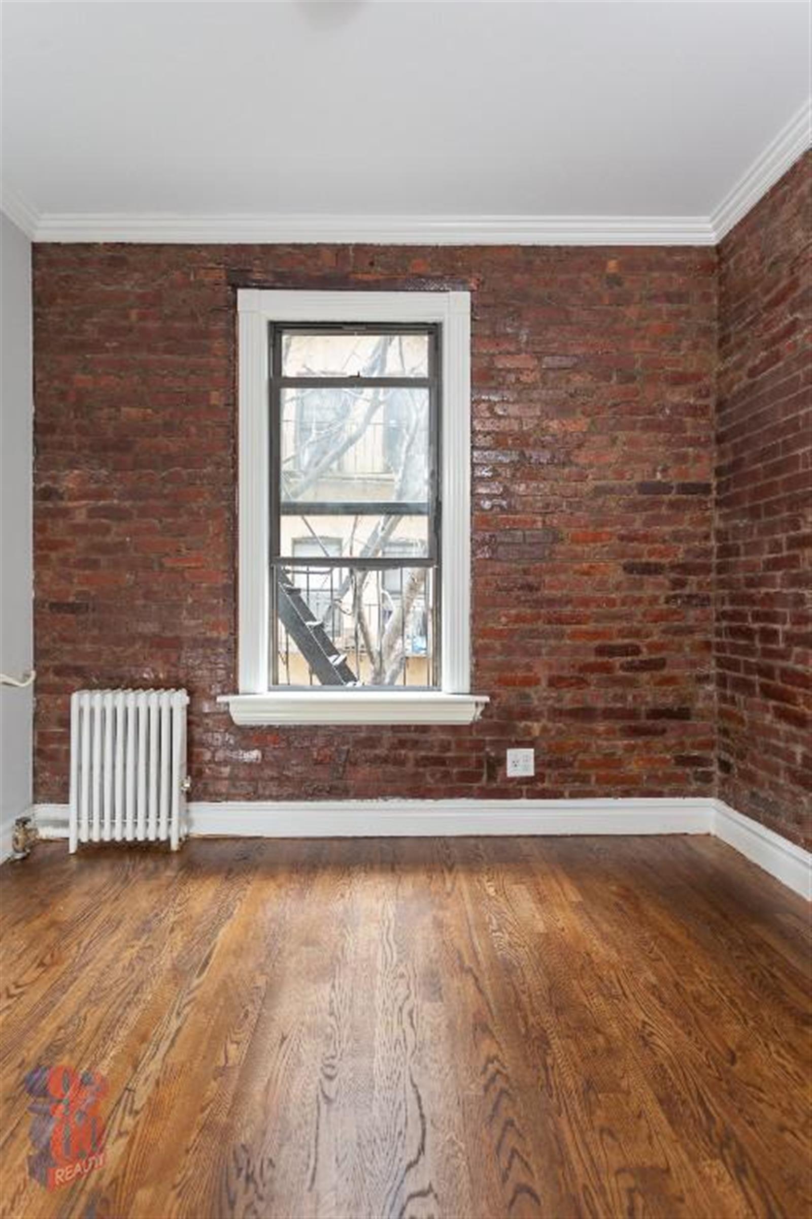 a view of a livingroom with wooden floor and a floor to ceiling window