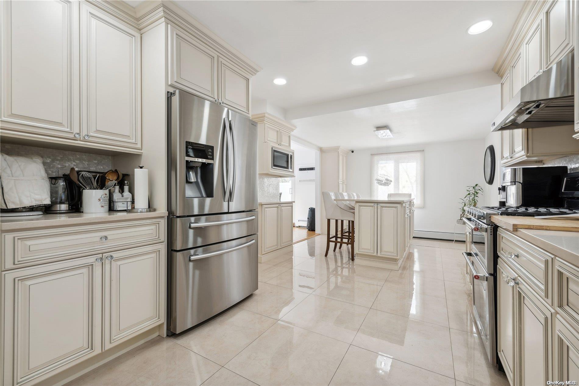 a kitchen with stainless steel appliances white cabinets and a refrigerator