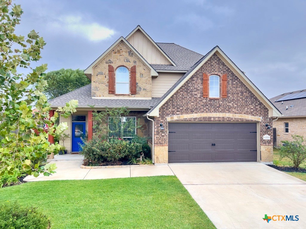 a front view of a house with garden