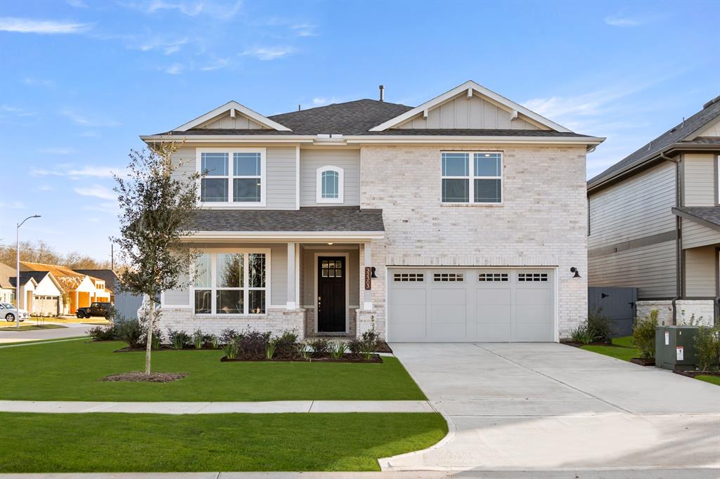 a front view of a house with a yard and garage