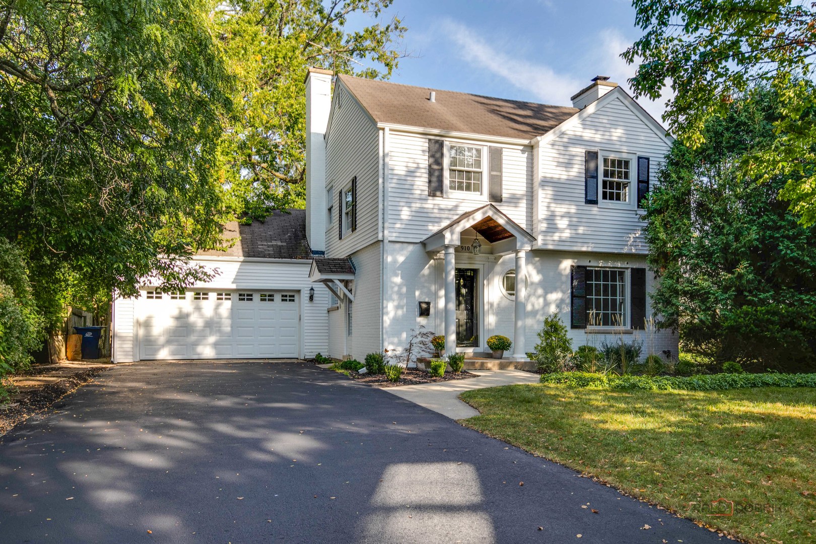 a front view of a house with a yard garage and outdoor seating