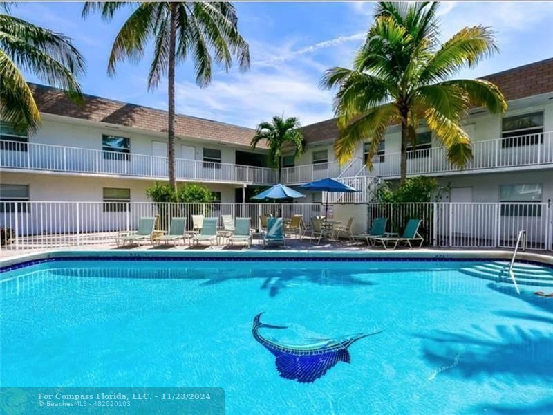 a swimming pool with outdoor seating and yard