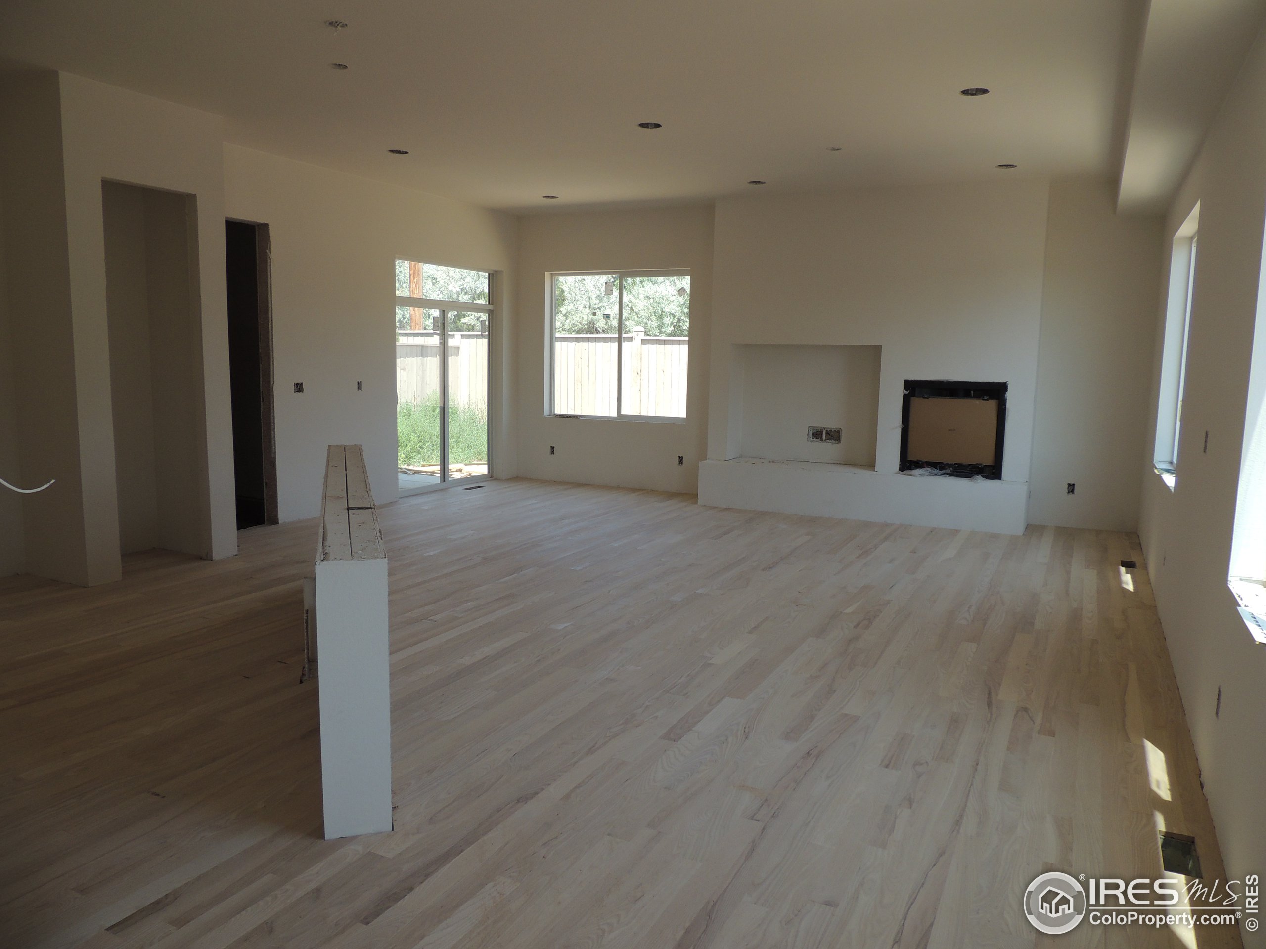 a view of a room with wooden floor and window