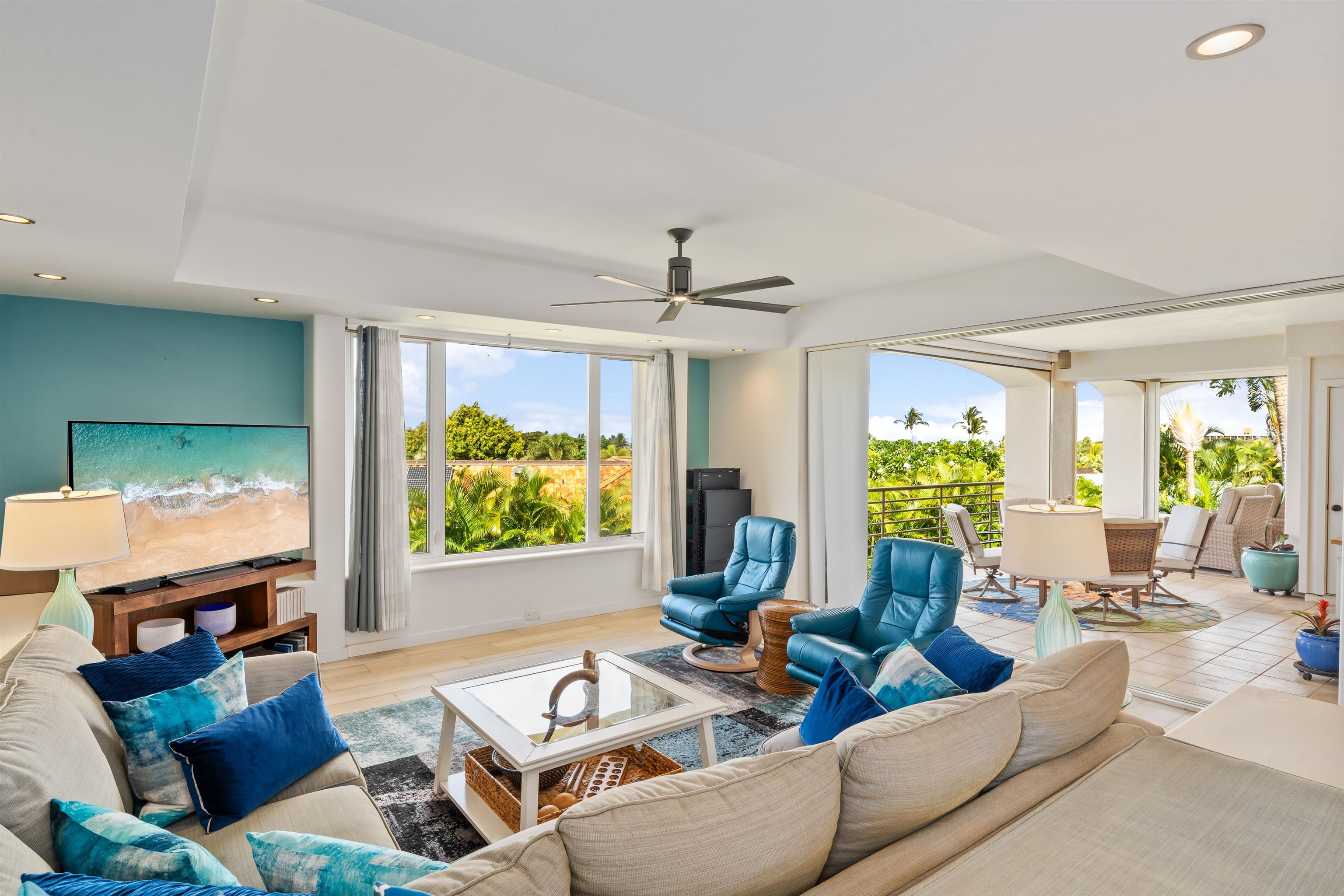 a living room with furniture a large window and a flat screen tv