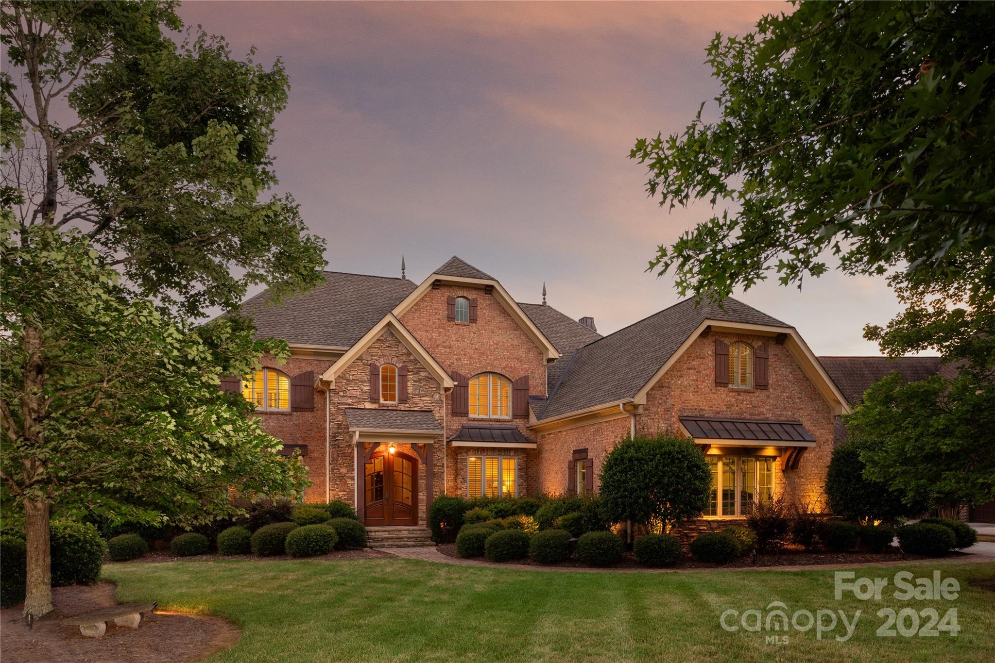 a front view of a house with a garden