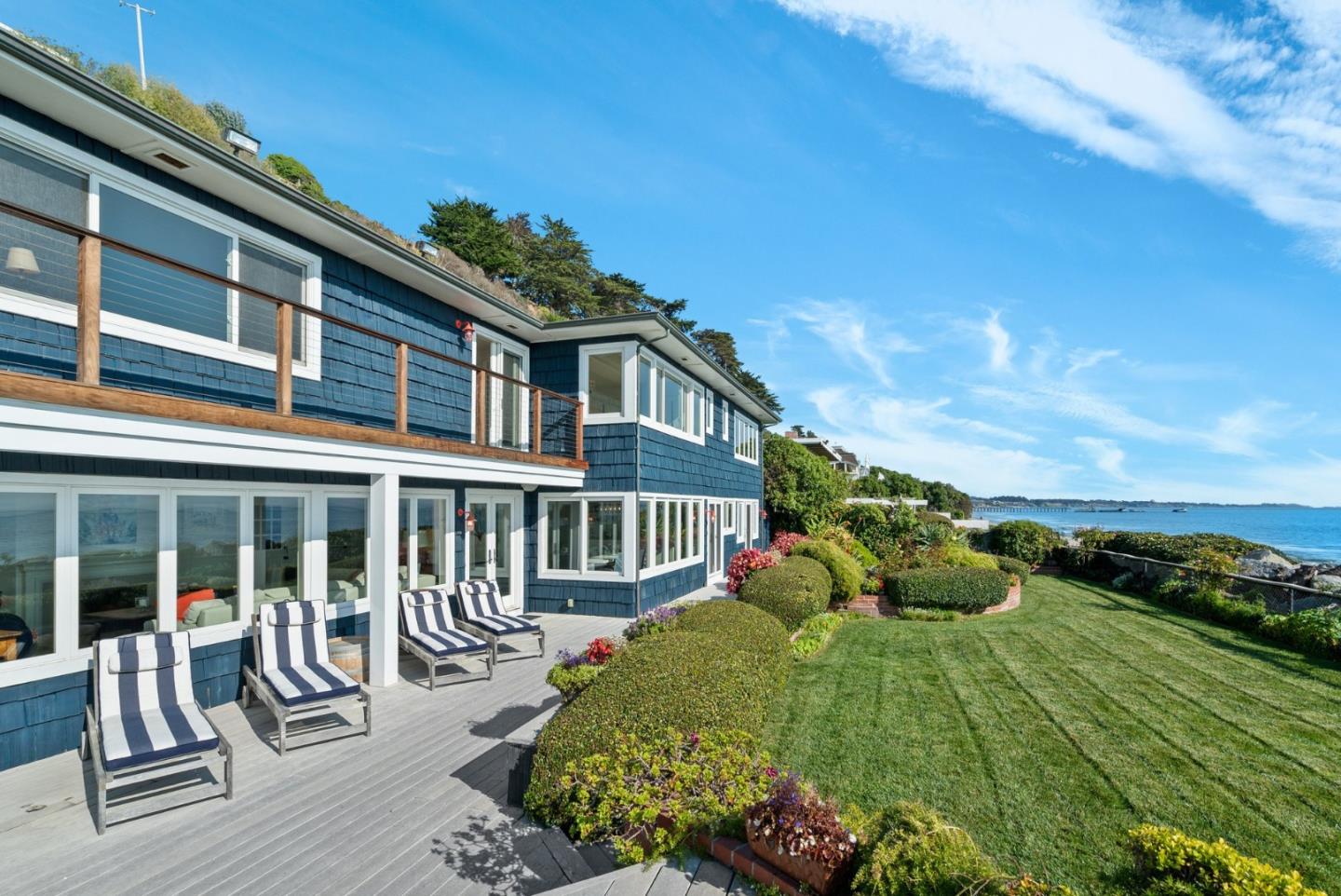 a view of a house with backyard sitting area and garden