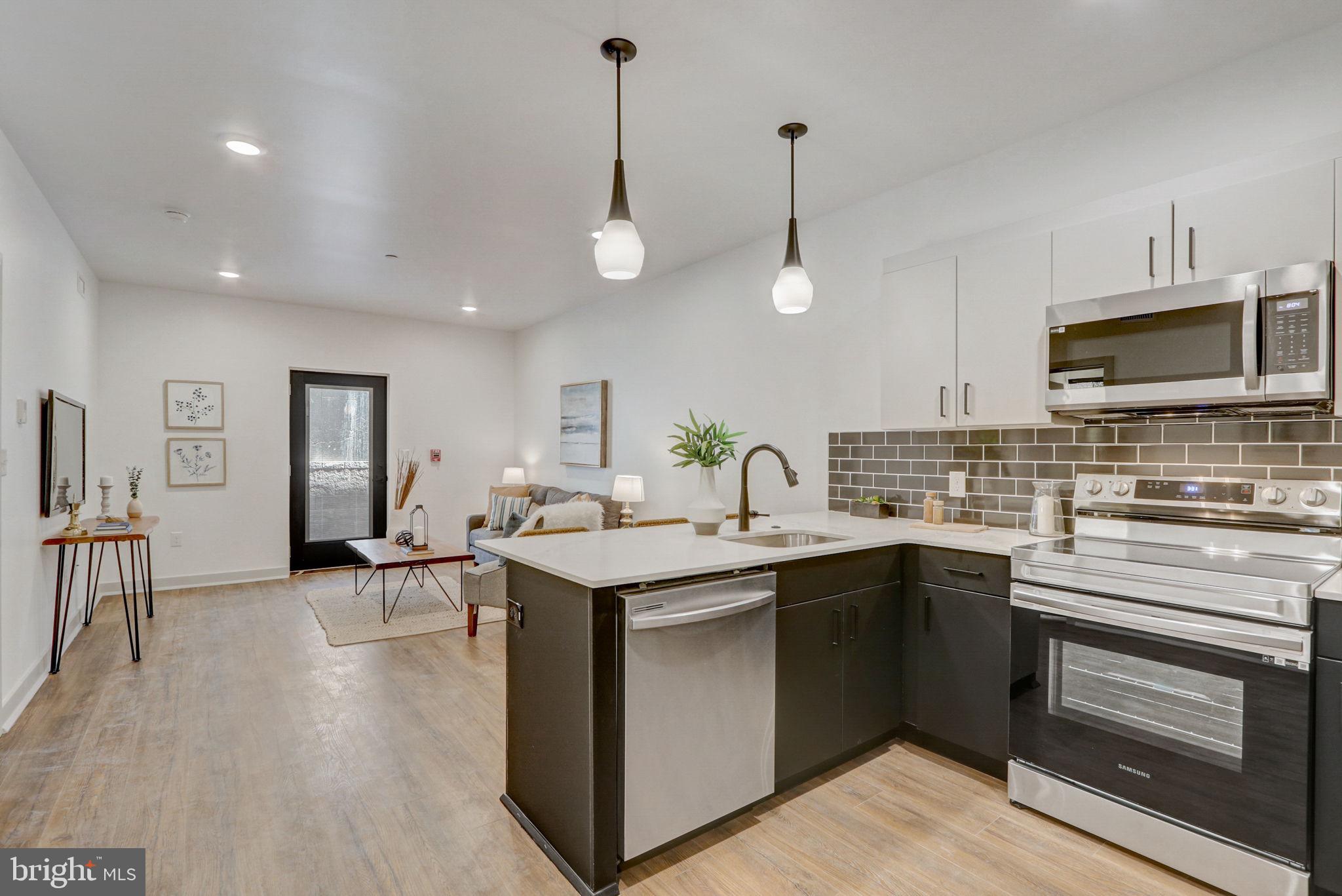 a kitchen with a sink stove and microwave