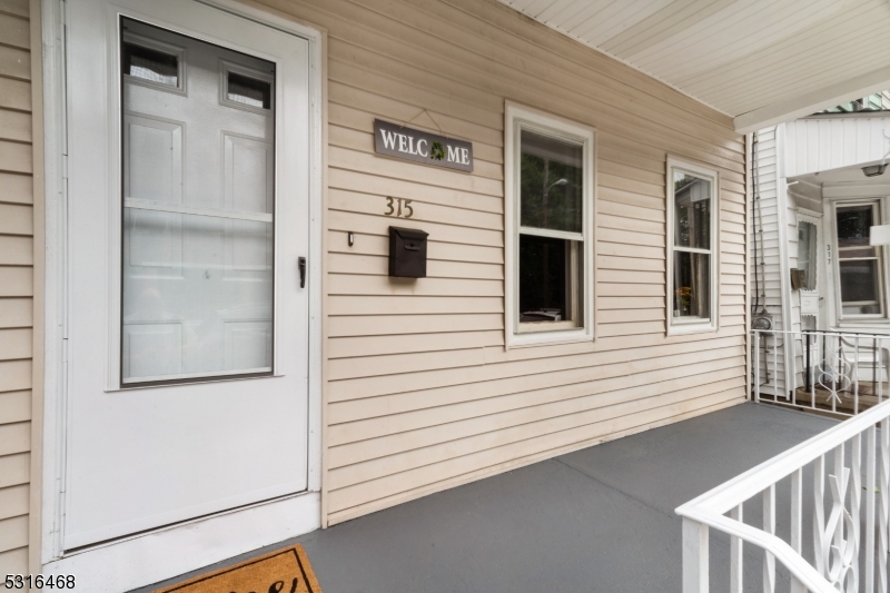 a view of a balcony with a door and wooden floor