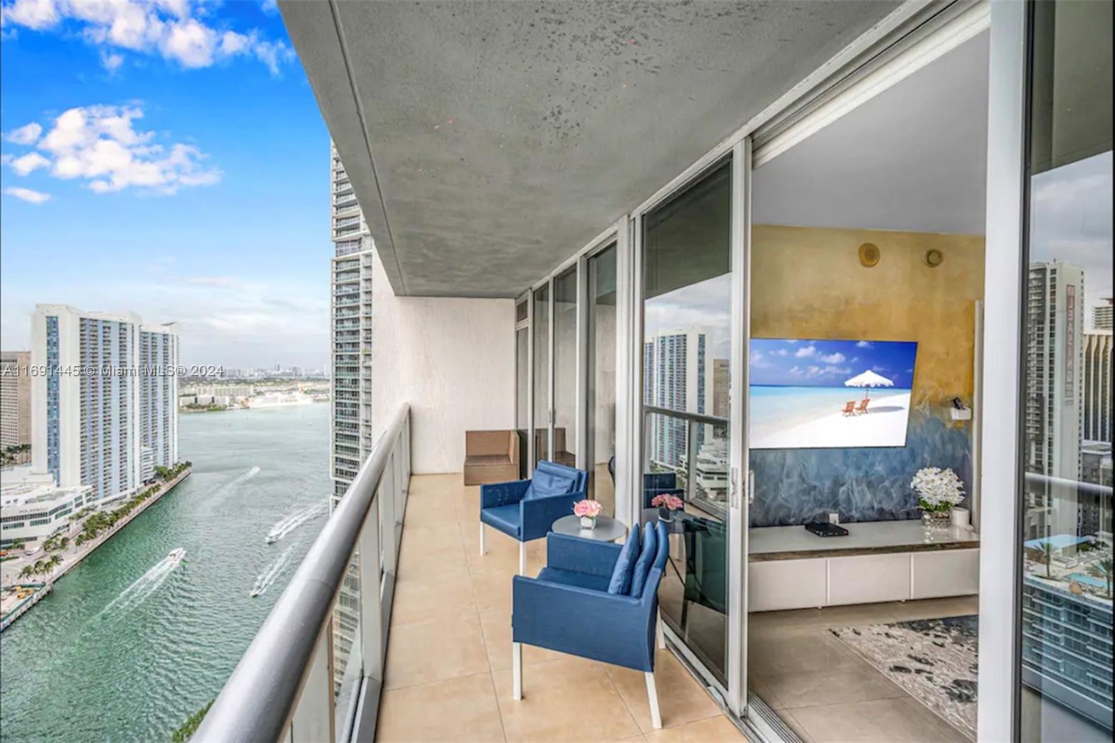 a balcony with view of living room and chandelier