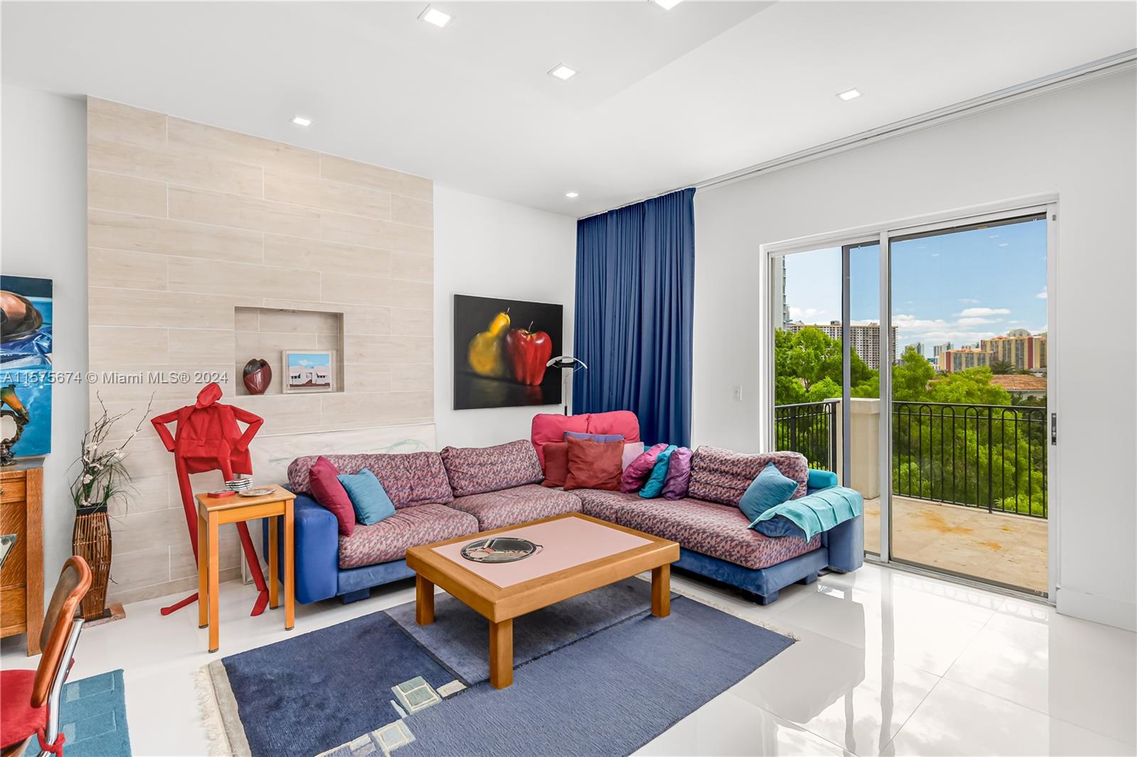 a living room with furniture and a floor to ceiling window