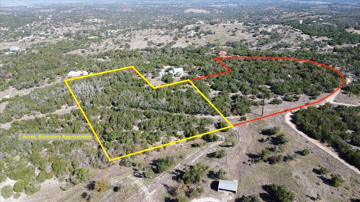 an aerial view of a residential houses with outdoor space