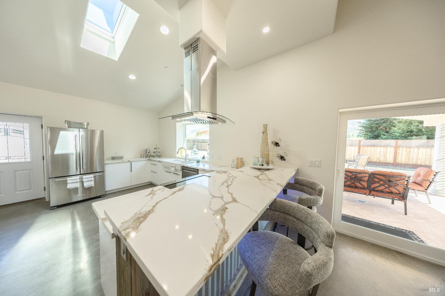 Stunning Quartz Counters over Bar top and Kitchen, connecting to Outdoor Covered patio