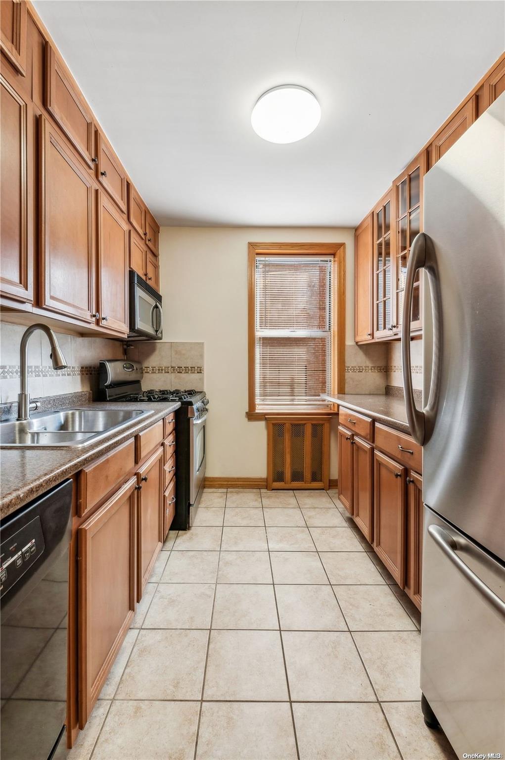 a kitchen with stainless steel appliances granite countertop a sink and a stove