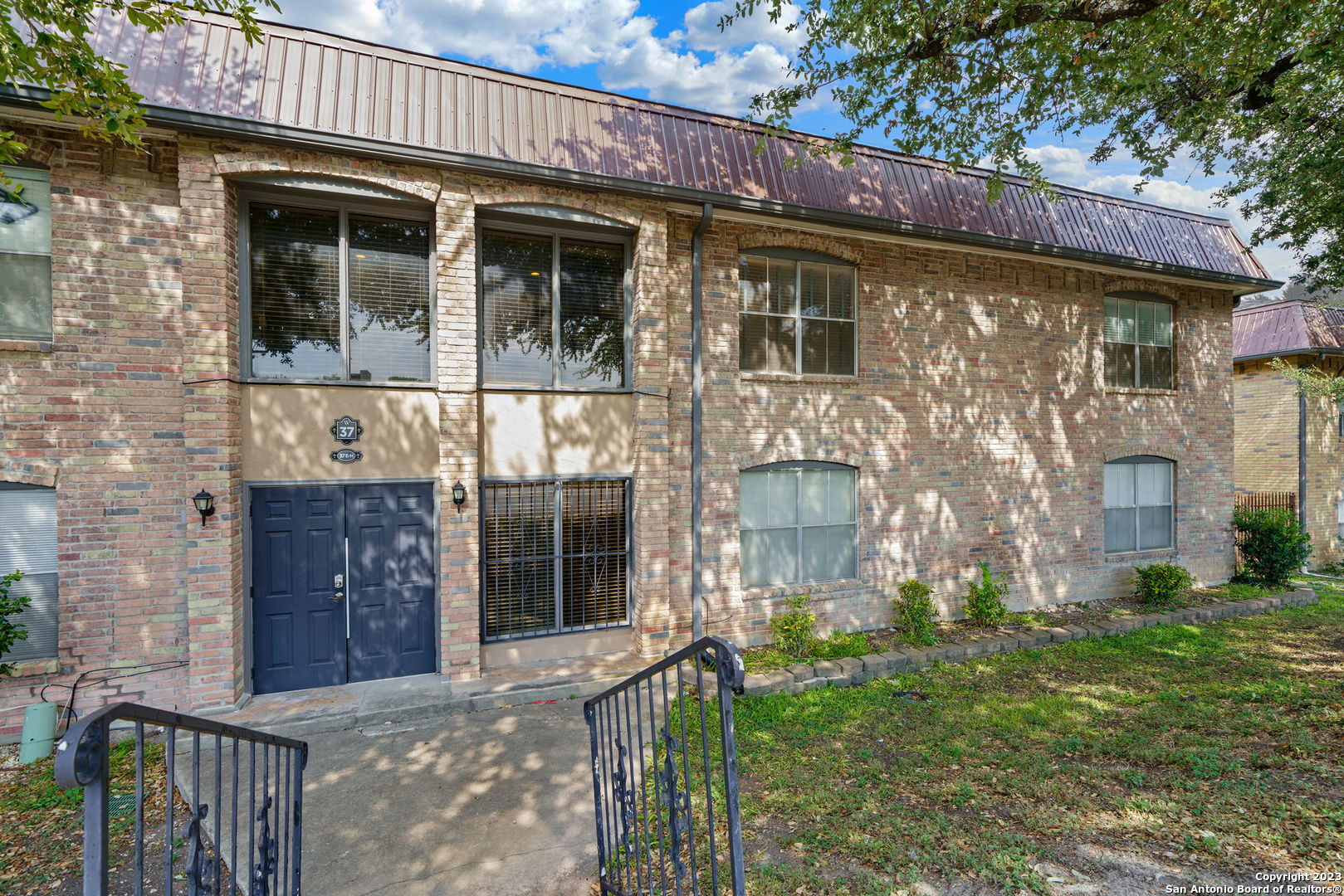 a front view of a house with a yard