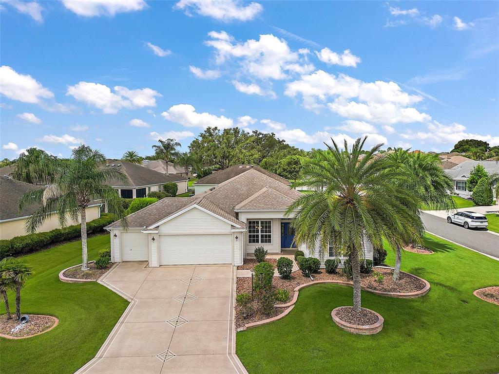 a aerial view of a house with swimming pool garden and patio