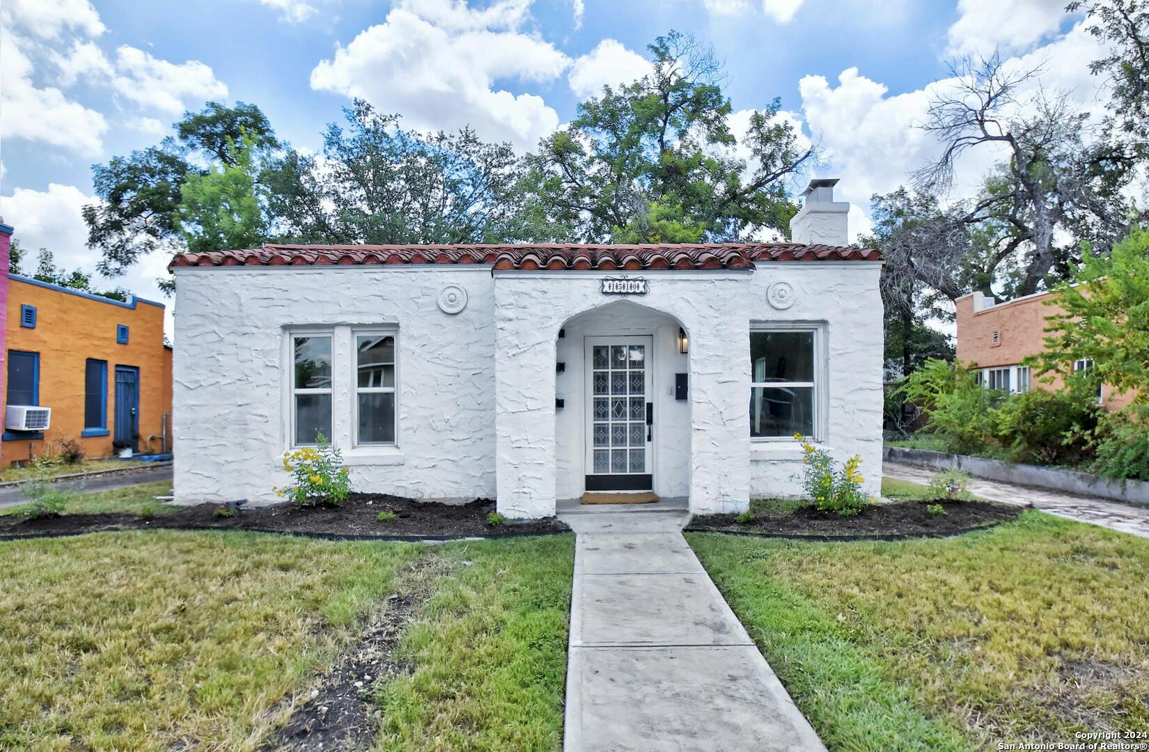 a front view of a house with a yard