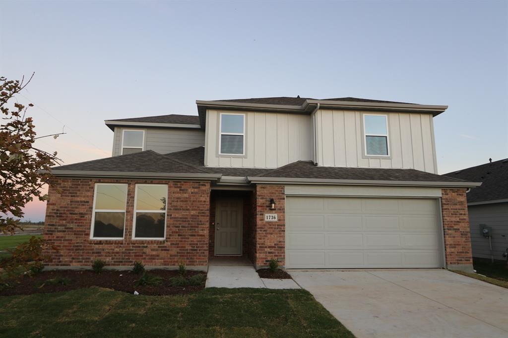 a front view of a house with a garage