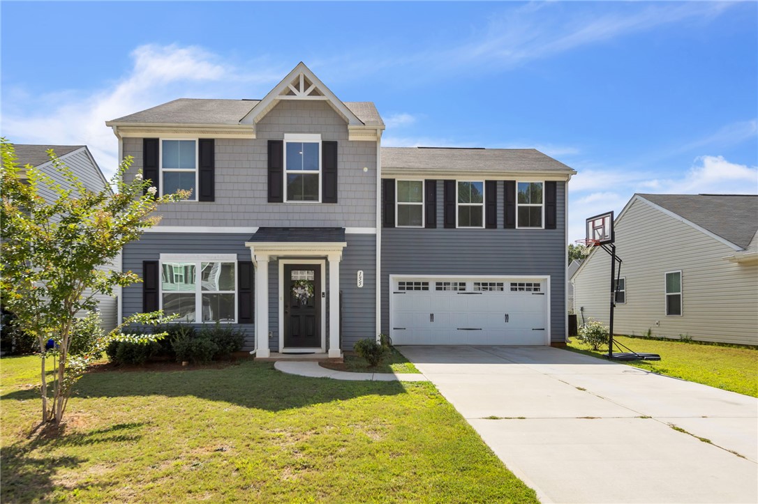 Home has two toned vinyl and shake siding