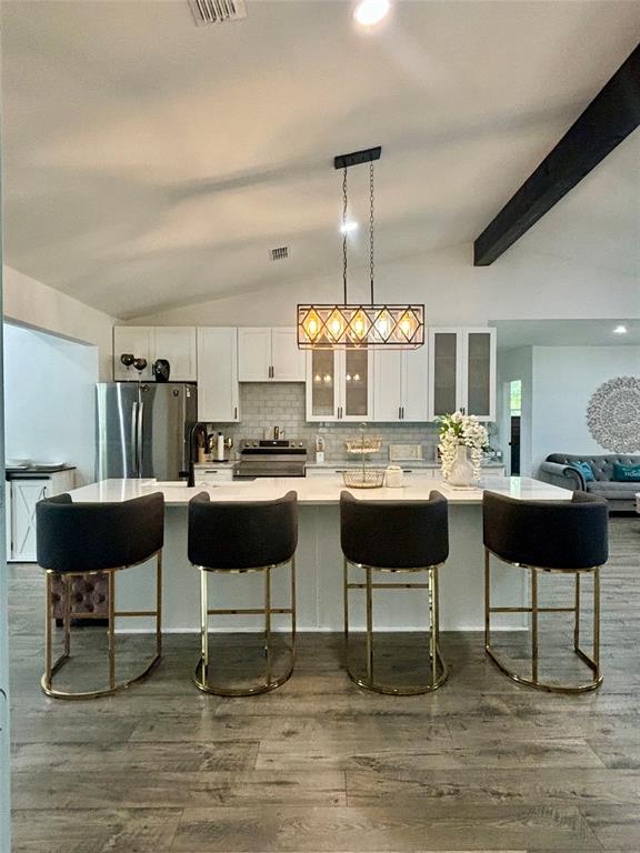 a kitchen with a dining table and chairs