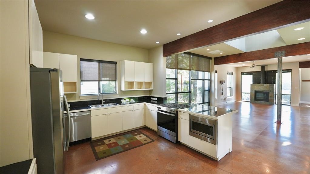 a kitchen with a stove a refrigerator and wooden cabinets