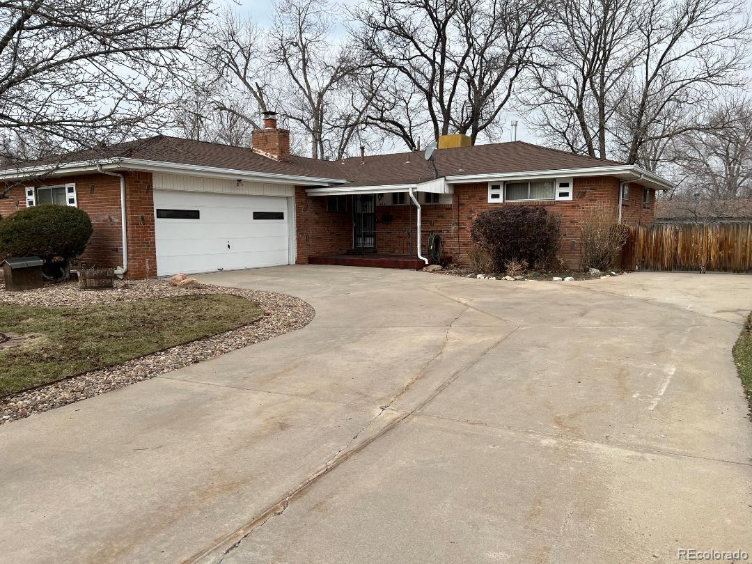 a front view of a house with a yard and a garage