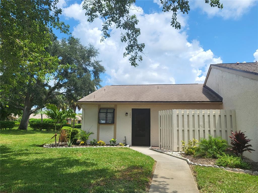 a front view of a house with a garden