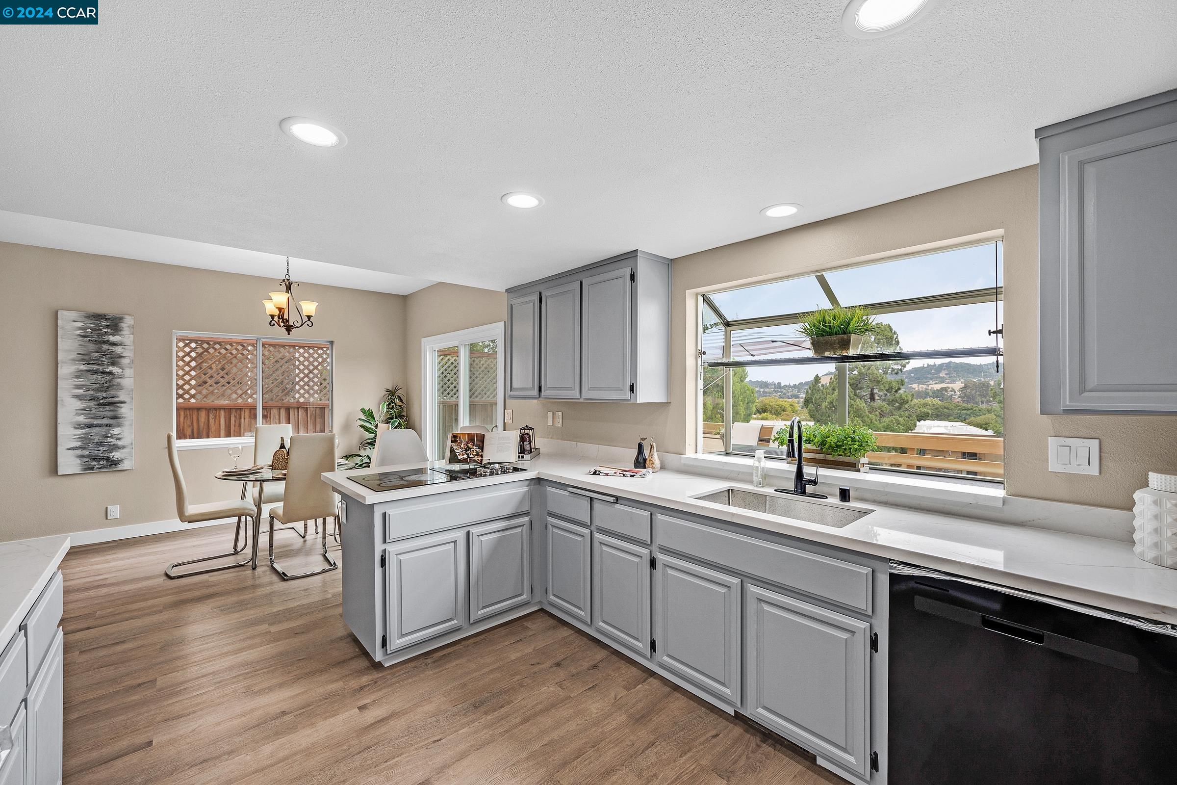 a kitchen with a sink cabinets and wooden floor