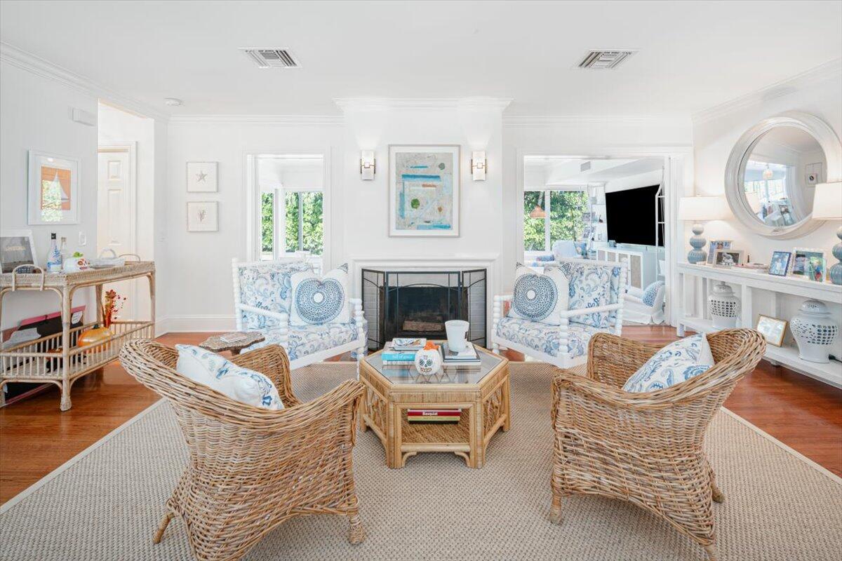 a living room with furniture a large window and a fireplace