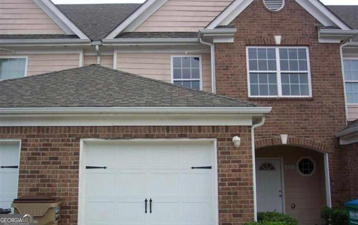 a front view of a house with garage