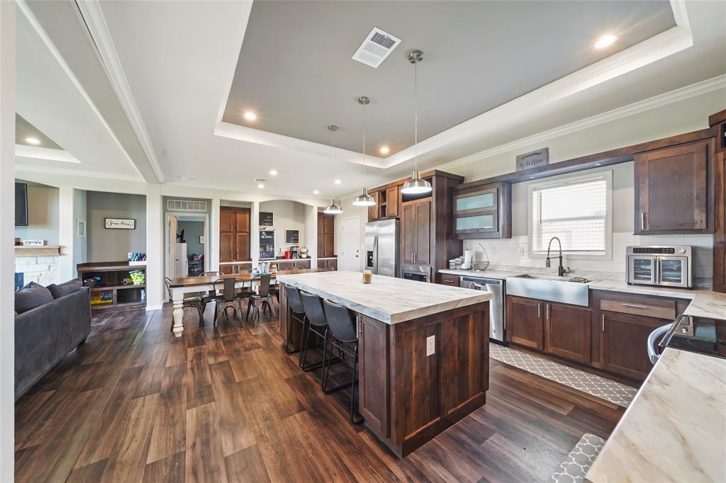 a kitchen with lots of counter top space and view of living room