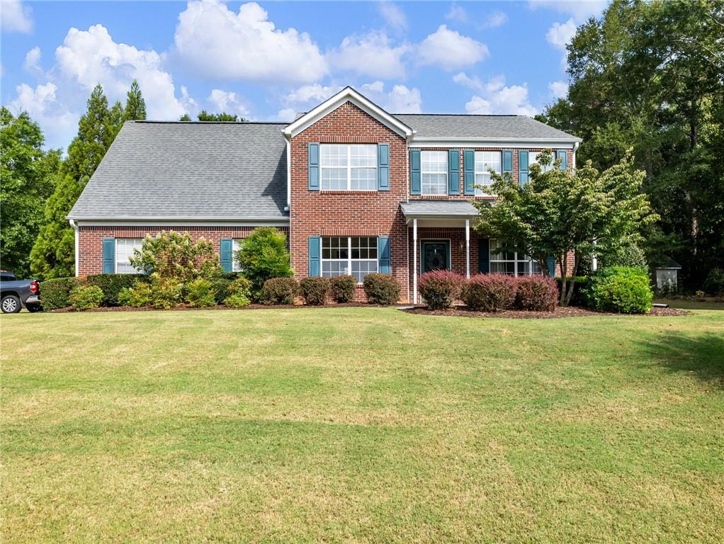 a front view of a house with a yard