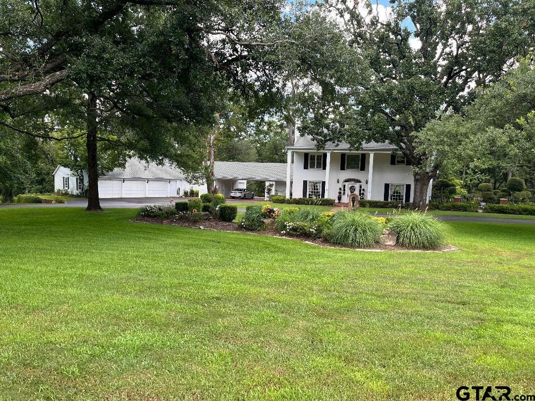 a house view with a sitting space and garden