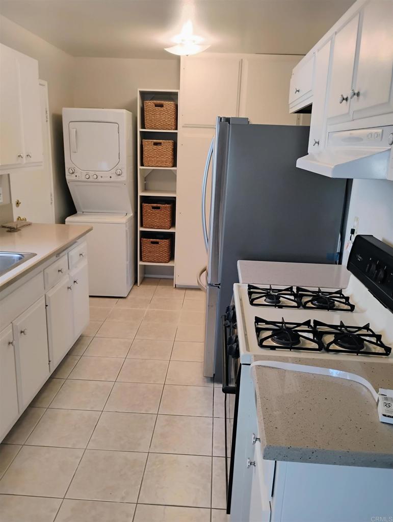 a kitchen with stainless steel appliances a stove and a refrigerator