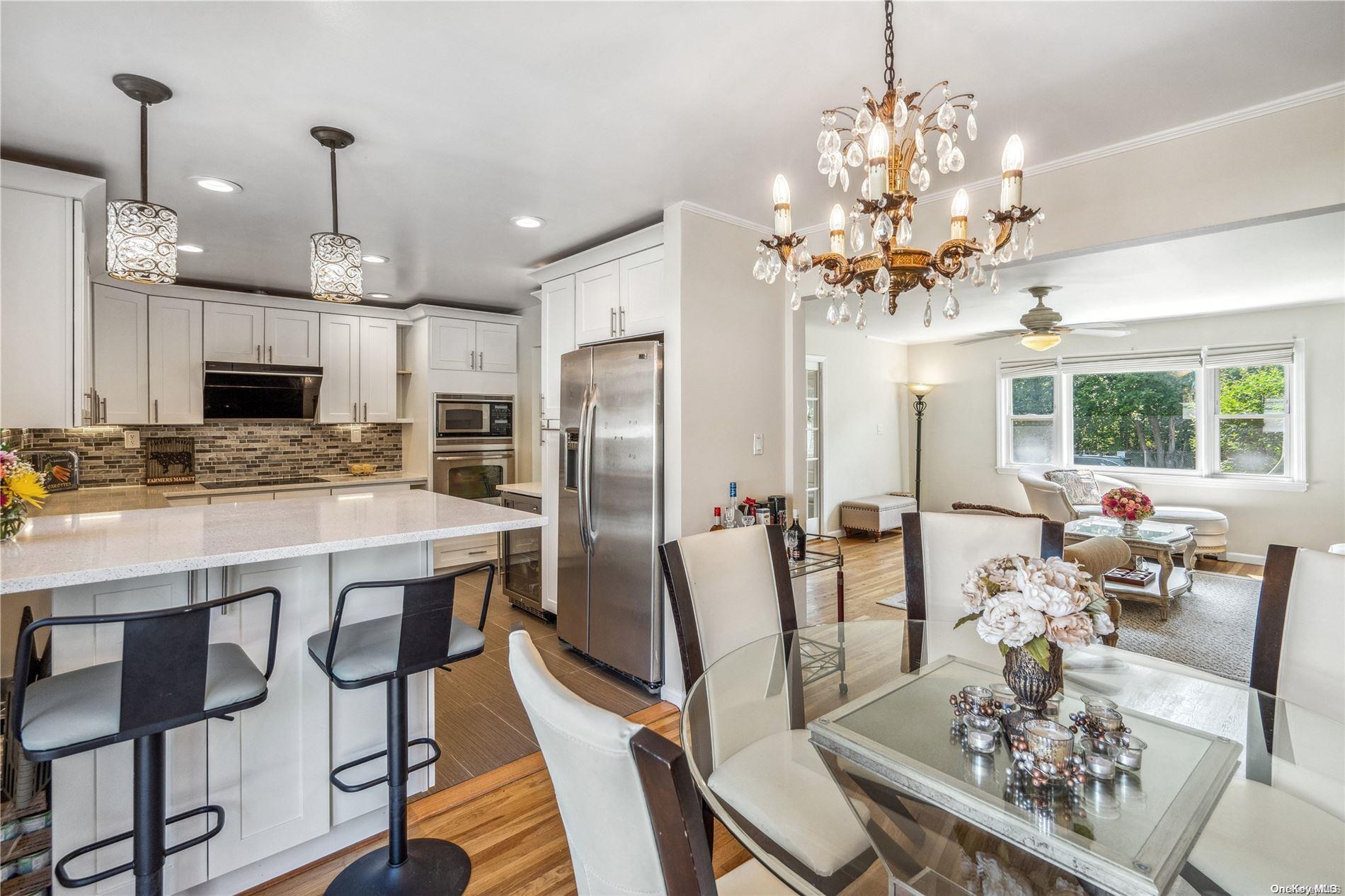 a large kitchen with a table and chairs