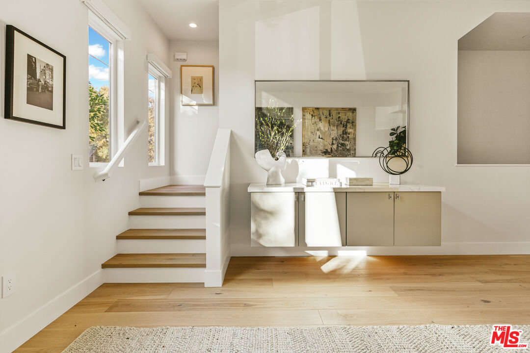 a view of a kitchen with furniture and staircase