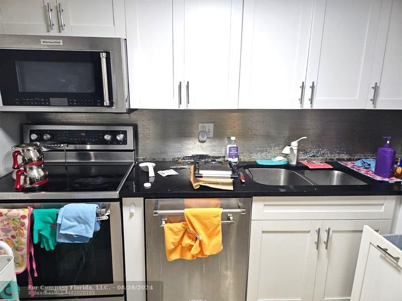 a kitchen with a stove and a microwave