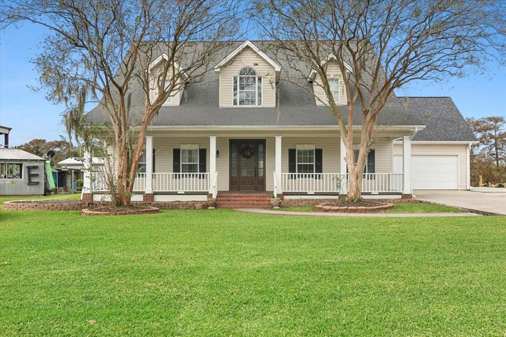 a view of a house with a yard patio and fire pit