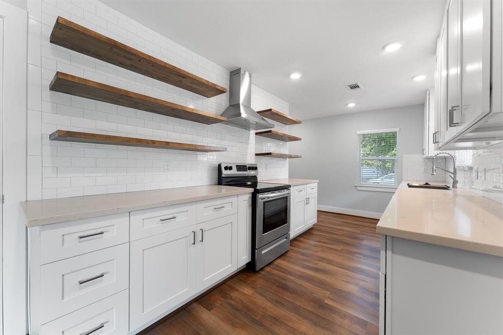 a kitchen with granite countertop white cabinets and white appliances