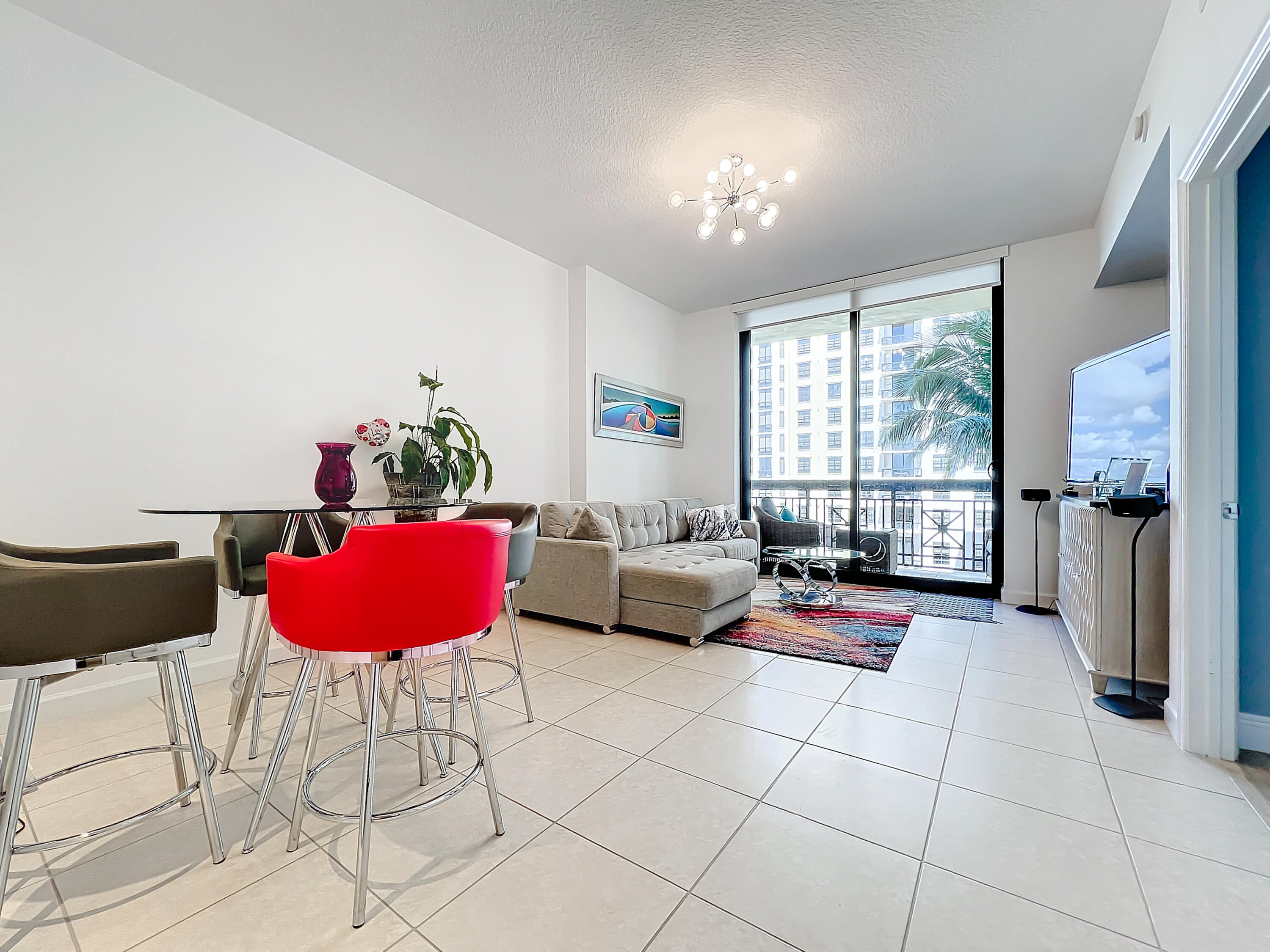 a living room with furniture and a floor to ceiling window