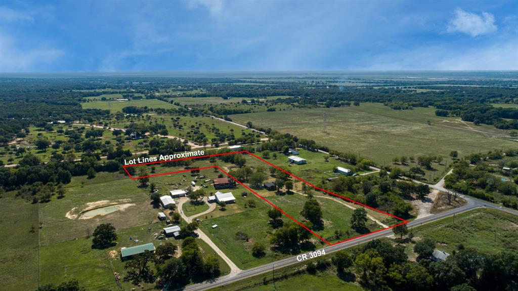 an aerial view of residential houses with outdoor space and river