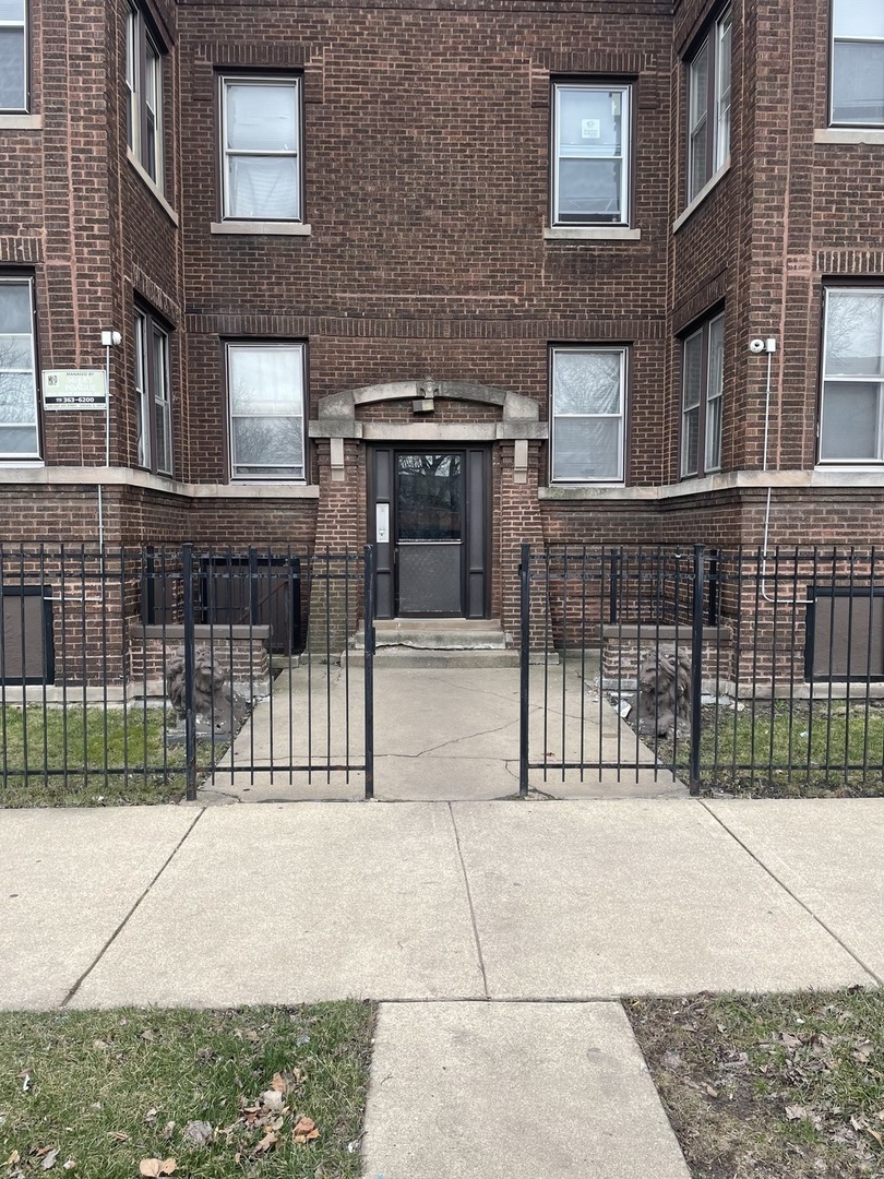 a view of a brick house with many windows