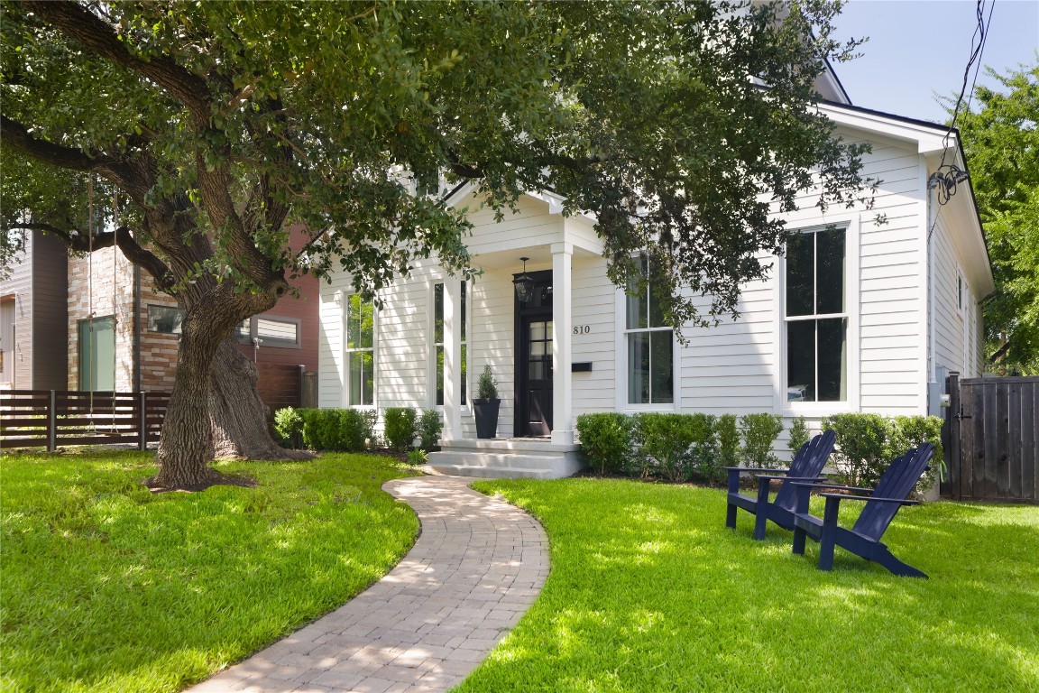 a front view of a house with garden