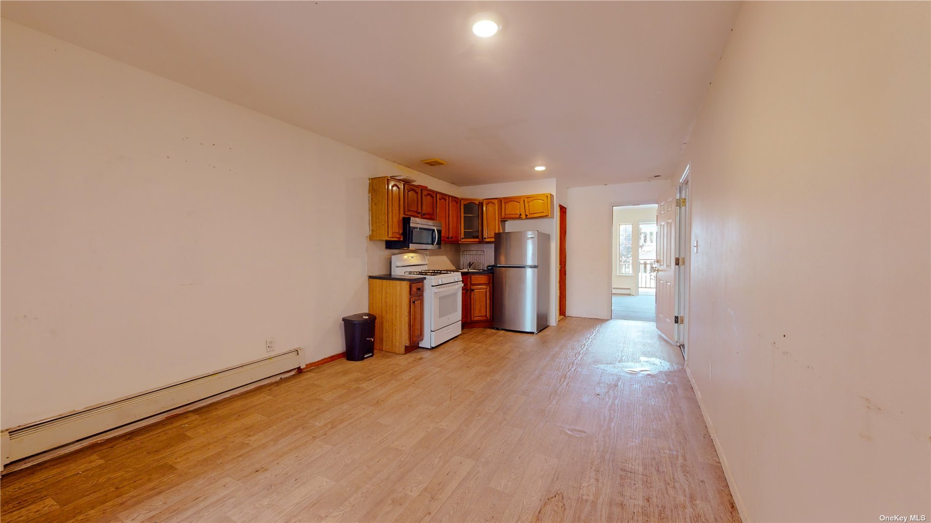 a view of a kitchen with furniture and wooden floor