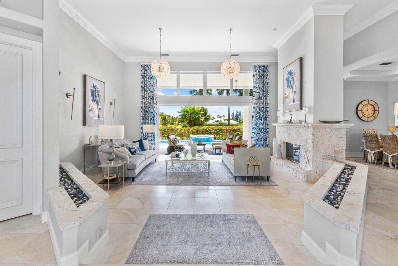 a living room with furniture and a chandelier