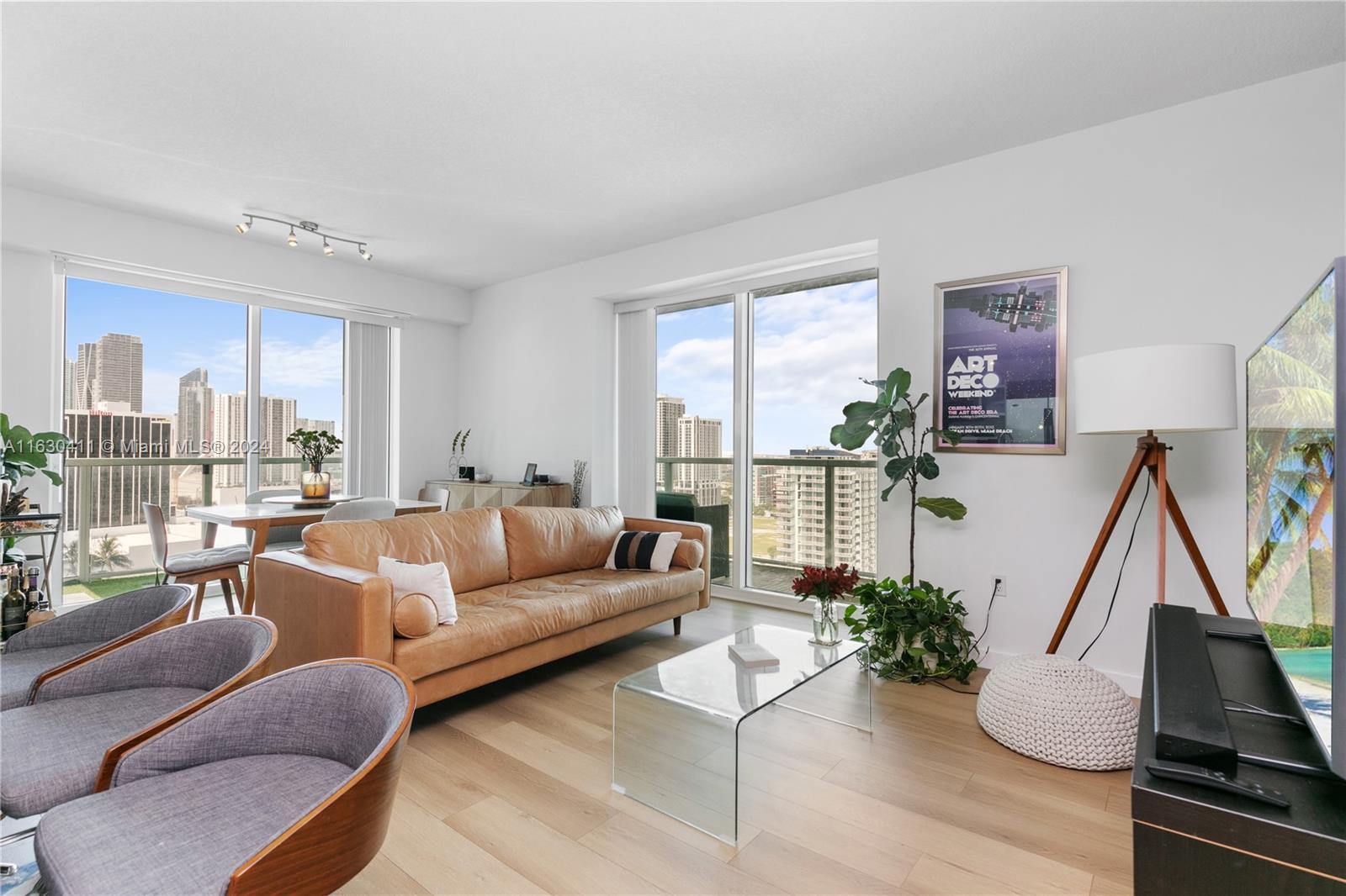 a living room with furniture next to a large window